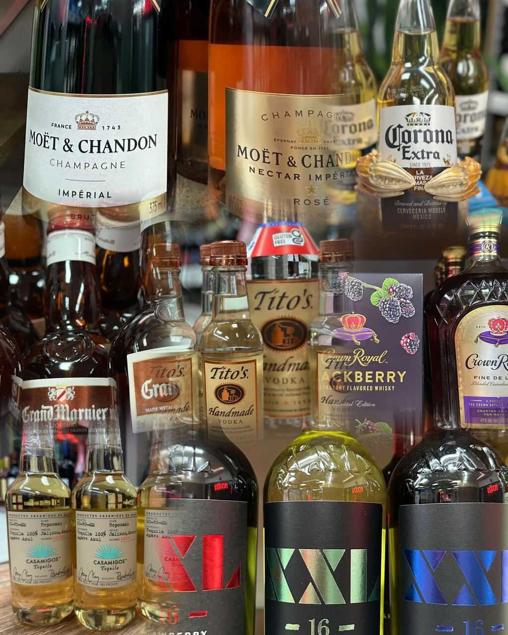 Various liquor bottles, including champagne, beer, and whiskey, displayed on shelves.